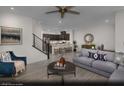 Open-concept living room and kitchen area with modern furnishings and ample natural light at 6698 Nimbus Ave # Lot 17, Las Vegas, NV 89130