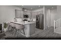 Stylish kitchen with stainless steel appliances and a sleek countertop bar area at 6716 Nimbus Ave # Lot 14, Las Vegas, NV 89130
