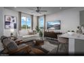 Bright living room with modern furniture, ceiling fan, and ample natural light at 6716 Nimbus Ave # Lot 14, Las Vegas, NV 89130