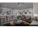 Open-concept living space with modern kitchen, dining area, and comfortable seating at 6716 Nimbus Ave # Lot 14, Las Vegas, NV 89130