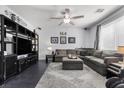 Comfortable living room featuring a large sectional sofa, decorative shelving, and plenty of natural light at 6857 Stone Tower Ct, Las Vegas, NV 89149