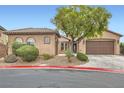 Inviting single-story home with well-maintained desert landscaping and attached garage at 7404 Eggshell Dr, North Las Vegas, NV 89084