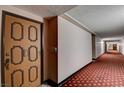 Hallway leading to Unit 127 with patterned carpet and door at 745 N Royal Crest Cir # 127, Las Vegas, NV 89169