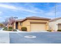 Single-story home with two-car garage, desert landscaping, and neighborhood street at 7611 Redcloud Peak St St, Las Vegas, NV 89166