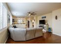 Open living room with hardwood floors, ceiling fan, and ample natural light at 7611 Redcloud Peak St St, Las Vegas, NV 89166