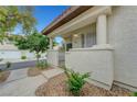 Inviting covered front porch with a gated entrance and desert landscaping at 8012 Desire Ave, Las Vegas, NV 89128
