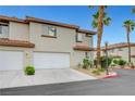 Well-maintained townhome with a two-car garage, desert landscaping, and a stucco exterior at 8012 Desire Ave, Las Vegas, NV 89128