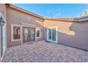 Stunning courtyard featuring brick pavers and decorative double door main entry to the home at 8212 Cabin Springs Ave, Las Vegas, NV 89131