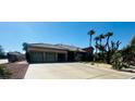 Single-story home featuring a three-car garage, desert landscaping, and stone accents at 8225 Fulton Ranch St, Las Vegas, NV 89131