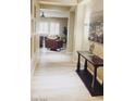 Hallway featuring wood floors, recessed art niche, and views into the living area at 8225 Fulton Ranch St, Las Vegas, NV 89131