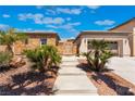 Charming single-story home with stone accents, lush desert landscaping, and a cozy walkway at 8536 Grand Palms Cir, Las Vegas, NV 89131
