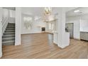 Open floor plan with modern wood floors, a fireplace, and a view into the bright kitchen at 8904 Meisenheimer Ave, Las Vegas, NV 89143