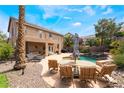 Relaxing backyard featuring pool, comfortable seating, and desert landscaping at 11285 Fiesole St, Las Vegas, NV 89141