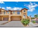 Inviting two-story townhome featuring a private garage, lovely balcony, and colorful landscaping at 1185 Via Dimartini, Henderson, NV 89052