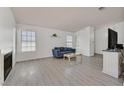 Inviting living room with wood-look floors, a cozy fireplace, and bright, natural light at 1356 Pleasant Brook St, Las Vegas, NV 89142