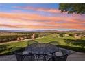 Outdoor seating area features a wrought-iron table and chairs with a stunning view of the valley at 1409 Pueblo Dr, Boulder City, NV 89005