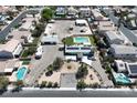 Expansive aerial view of property featuring a pool, garage, RV parking, desert landscaping, and space to roam at 1595 E Camero Ave, Las Vegas, NV 89123
