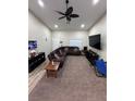 Spacious living room featuring neutral walls, ceiling fan, recessed lighting and carpeted floors at 1619 Tangerine Rose Dr, Las Vegas, NV 89142