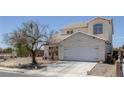 Charming two-story home with a two-car garage, desert landscaping, and a concrete driveway at 2147 Bridle Wreath Ln, Las Vegas, NV 89156