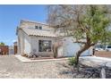 Inviting home with stucco siding, tile roof, desert landscaping, and an attached two-car garage at 2147 Bridle Wreath Ln, Las Vegas, NV 89156