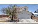 Charming home featuring a two-car garage, landscaped yard, and classic architecture at 2147 Bridle Wreath Ln, Las Vegas, NV 89156