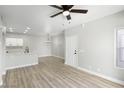 Spacious living area with light wood floors, seamlessly connecting to a modern kitchen at 2201 Ramsgate Dr # 327, Henderson, NV 89074