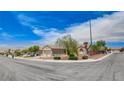 Corner-lot home featuring desert landscaping, a two-car garage, and well-maintained shrubs at 2804 Sapphire Desert Dr, Henderson, NV 89052