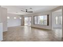 Spacious living room showcasing tile flooring, ample natural light, and a ceiling fan at 2804 Sapphire Desert Dr, Henderson, NV 89052