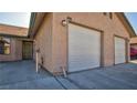Exterior view of the property featuring a two-car garage and front entrance at 305 Crosswind Way, Las Vegas, NV 89145