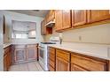 Functional kitchen design with wood cabinets, white countertops, and standard appliances at 305 Crosswind Way, Las Vegas, NV 89145