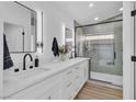 Modern bathroom featuring double sinks, sleek fixtures, and a glass-enclosed shower at 3109 Siena Cir, Las Vegas, NV 89128