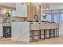 Modern kitchen featuring quartz countertops, stainless steel appliances, and an island with seating at 3109 Siena Cir, Las Vegas, NV 89128
