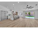 Open kitchen features an island with barstool seating and stainless steel refrigerator at 3109 Siena Cir, Las Vegas, NV 89128