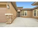Inviting front entrance featuring stone accents and a double door entry at 3805 Specula Wing Dr, North Las Vegas, NV 89084