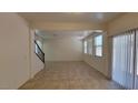 Spacious living area boasts tile floors, recessed lighting, and sliding door access to the backyard at 386 Botanic Gardens Dr, Las Vegas, NV 89148