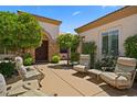 Relaxing outdoor courtyard with comfortable seating surrounded by lush landscaping and trees at 4208 Agosta Luna Pl, Las Vegas, NV 89135