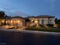 Elegant exterior view of the home showcasing its warm lighting, landscaping, and inviting facade at 4208 Agosta Luna Pl, Las Vegas, NV 89135