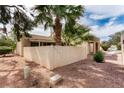 Exterior view of a charming home showcasing desert landscaping and architectural details at 4213 Essex Green Ct, Las Vegas, NV 89110