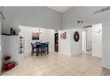 Open-concept living area with neutral walls, tiled floors, and adjacent dining space at 4213 Essex Green Ct, Las Vegas, NV 89110