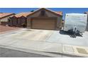 Charming single-story home featuring a desert landscape, barrel tile roof, and two-car garage at 5020 Wildroot Rd, Las Vegas, NV 89130