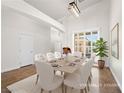 Bright dining room with a large window and modern lighting fixture at 5120 Mirage Garden St, Las Vegas, NV 89130