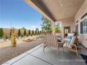 Outdoor patio area with outdoor seating and a fire pit for entertaining guests at 5120 Mirage Garden St, Las Vegas, NV 89130