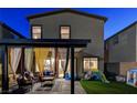 Charming backyard with covered patio, grass, and play area, providing a fun and relaxing outdoor environment at 5236 Sunstone Mesa Dr, Las Vegas, NV 89166