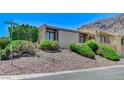 A well-maintained home with lovely desert landscaping and gorgeous mountain views in the background at 532 Greenbriar Pl, Boulder City, NV 89005