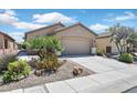 Charming single-story home featuring a well-manicured yard with desert landscaping and an attached two-car garage at 6039 Tokara Ave, Las Vegas, NV 89122