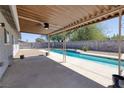 Covered patio provides shaded poolside lounging with a ceiling fan at 616 Fernbrook Dr, Henderson, NV 89002
