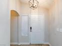A bright entryway featuring a classic white door with modern hardware, adjacent to a large window letting in natural light at 6337 Canyon Vista Ct, Las Vegas, NV 89156