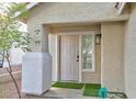 Inviting front entryway with a classic door, a small window, and a well-maintained exterior in a neutral color palette at 6337 Canyon Vista Ct, Las Vegas, NV 89156