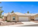 Inviting single-story home with desert landscaping and a convenient two-car garage at 7641 Sea Wind Dr, Las Vegas, NV 89128