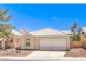 Attractive single-story home boasting a tidy front yard and an attached two-car garage at 7641 Sea Wind Dr, Las Vegas, NV 89128